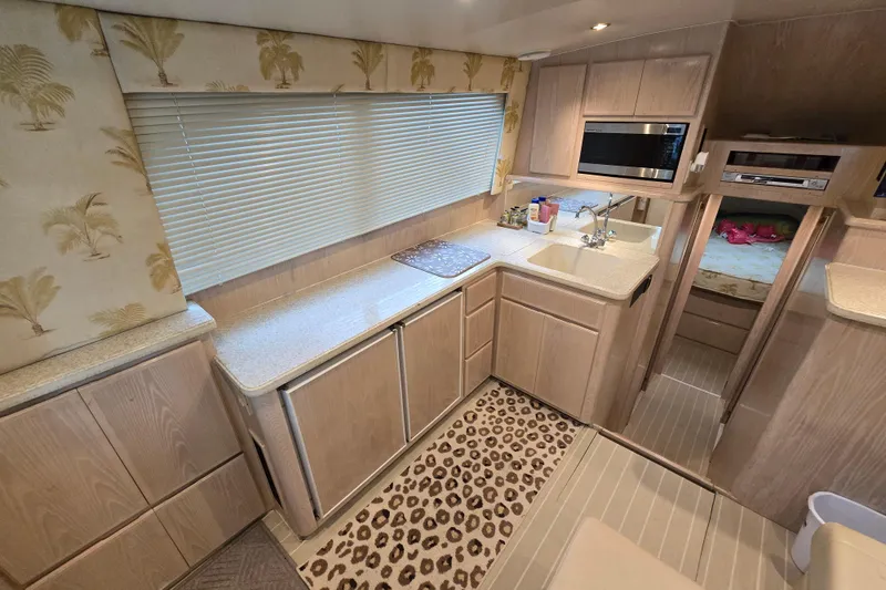 Slide: The Image of Interior of 2003 Henriques 35 Sportfisherman with modern kitchen and cozy sleeping area. - 17