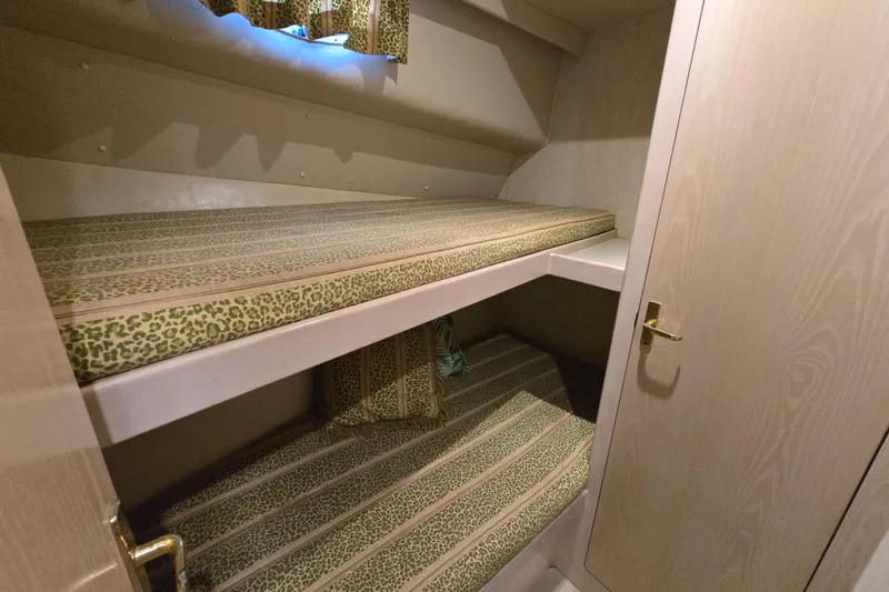 Slide: The Image of 2003 Henriques 35 Sportfisherman cabin with bunk beds and patterned bedding. - 22