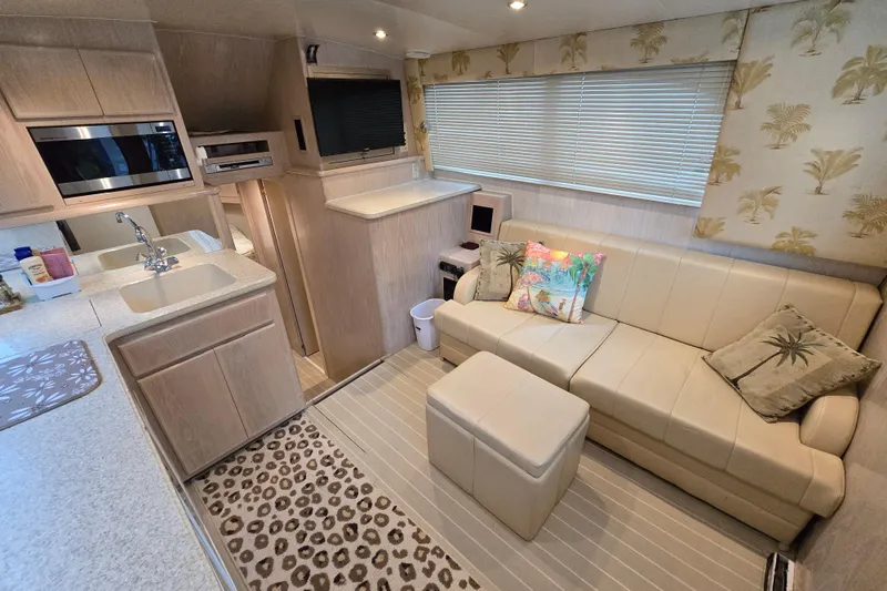 Slide: The Image of Luxurious interior of a 2003 Henriques 35 Sportfisherman yacht with modern kitchen and cozy seating. - 28