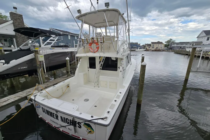 Slide: The Image of 2003 Henriques 35 Sportfisherman docked in a marina, overcast sky. - 3