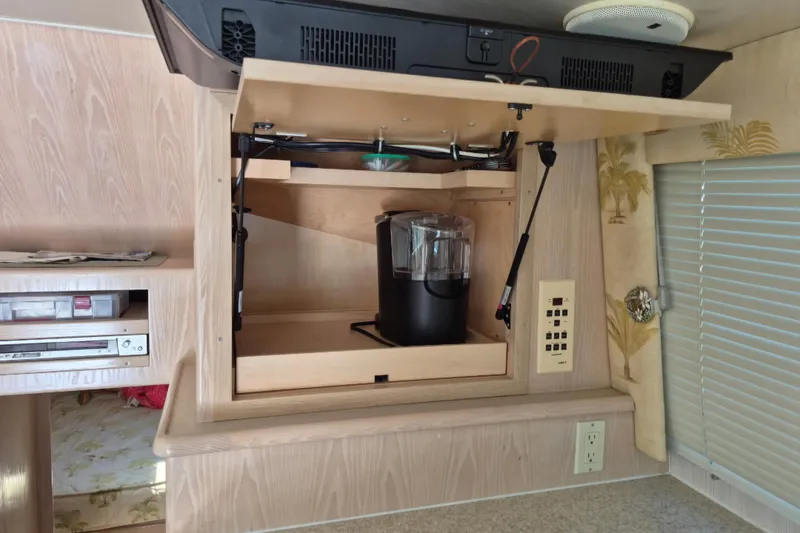 Slide: The Image of 2003 Henriques 35 Sportfisherman interior with a built-in coffee maker and storage. - 31