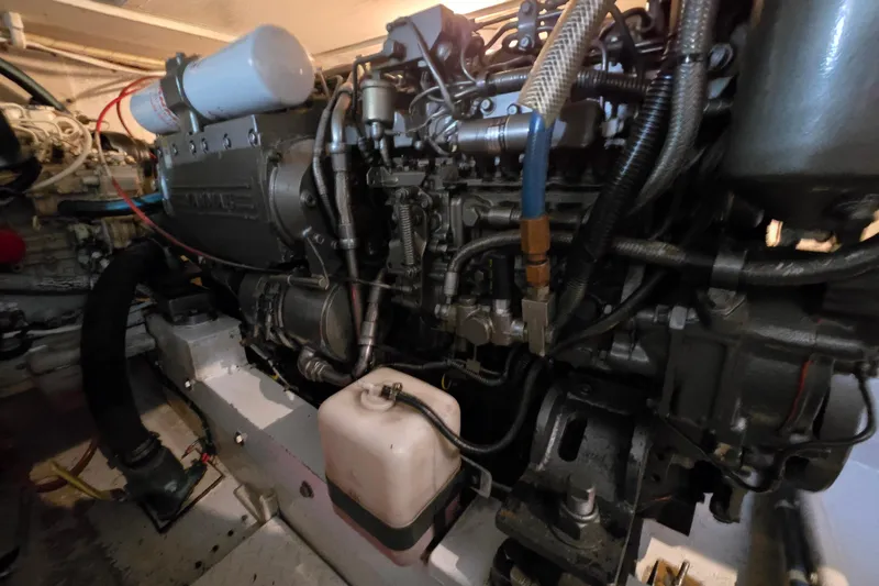 Slide: The Image of Engine room of a 2003 Henriques 35 Sportfisherman boat, showcasing detailed machinery. - 33