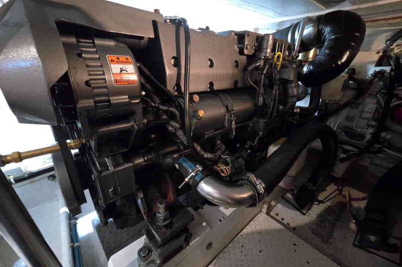 Slide: The Image of Engine compartment of a 2003 Henriques 35 Sportfisherman boat, showcasing detailed machinery. - 34