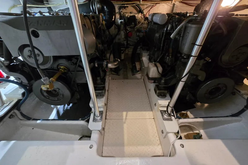 Slide: The Image of Engine room of a 2003 Henriques 35 Sportfisherman, showcasing dual Yanmar engines. - 35