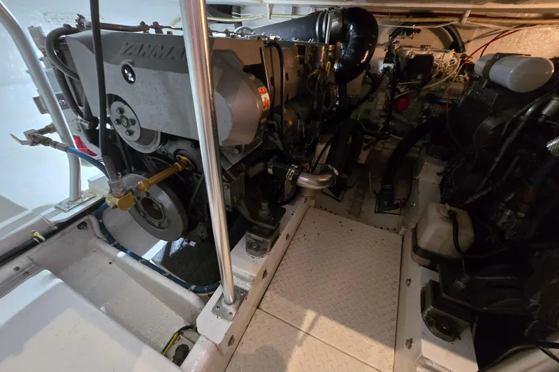 Slide: The Image of Engine room of a 2003 Henriques 35 Sportfisherman, featuring a Yanmar engine. - 37