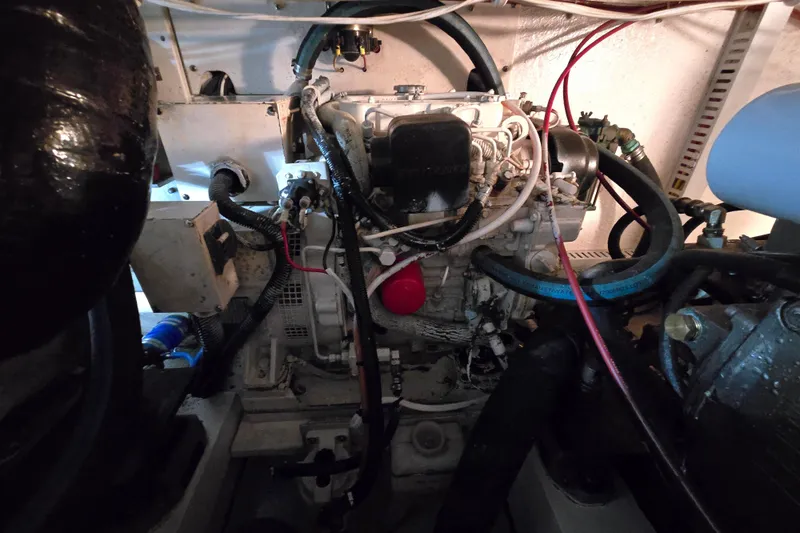 Slide: The Image of Engine room of a 2003 Henriques 35 Sportfisherman boat, showcasing mechanical components. - 38