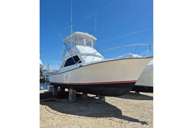 Slide: The Image of 2003 Henriques 35 Sportfisherman boat on dry dock under clear blue sky. - 6
