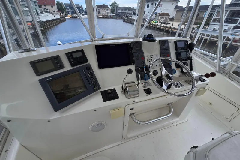 Slide: The Image of Helm of 2003 Henriques 35 Sportfisherman with navigation equipment and steering wheel, dockside view. - 8