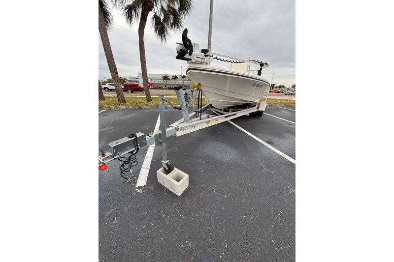 Slide: The Image of 2021 Pathfinder 2300 HPS boat on trailer in parking lot, overcast sky. - 11