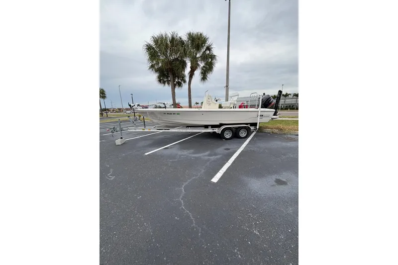 Slide: The Image of 2021 Pathfinder 2300 HPS boat on trailer in parking lot with palm trees. - 12