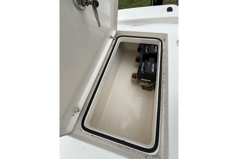 Slide: The Image of Open storage compartment with batteries in a 2021 Pathfinder 2300 HPS boat. - 14