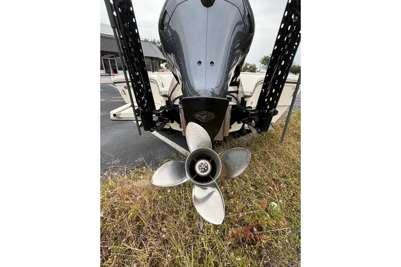 Slide: The Image of 2021 Pathfinder 2300 HPS boat propeller and motor, parked on grass. - 17