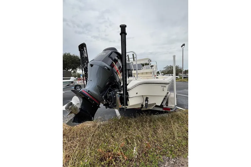 Slide: The Image of 2021 Pathfinder 2300 HPS boat with outboard motor on trailer in parking lot. - 18