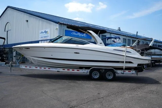 The Image of 2014 Sea Ray 270 SLX boat on trailer outside dealership. - 1