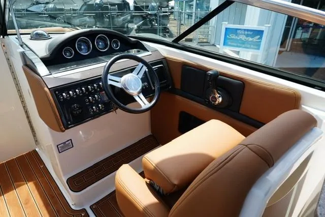 Slide: The Image of 2014 Sea Ray 270 SLX boat interior with steering wheel and control panel. - 12