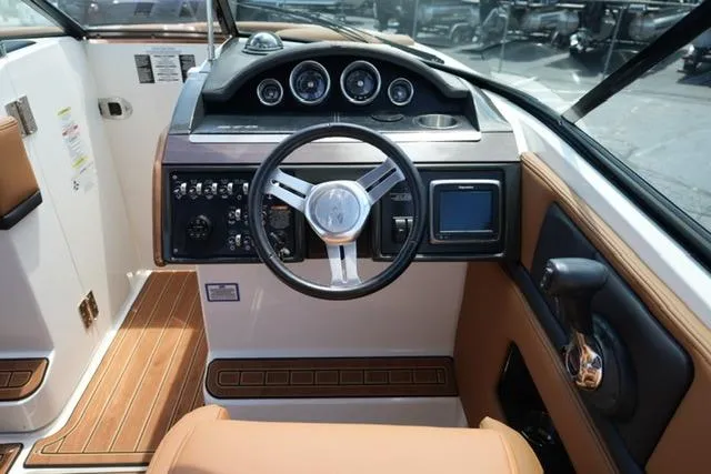 Slide: The Image of Interior cockpit of 2014 Sea Ray 270 SLX boat with steering wheel and control panel. - 13