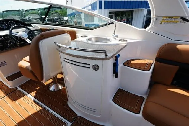 Slide: The Image of 2014 Sea Ray 270 SLX boat interior with sink and seating area. - 16