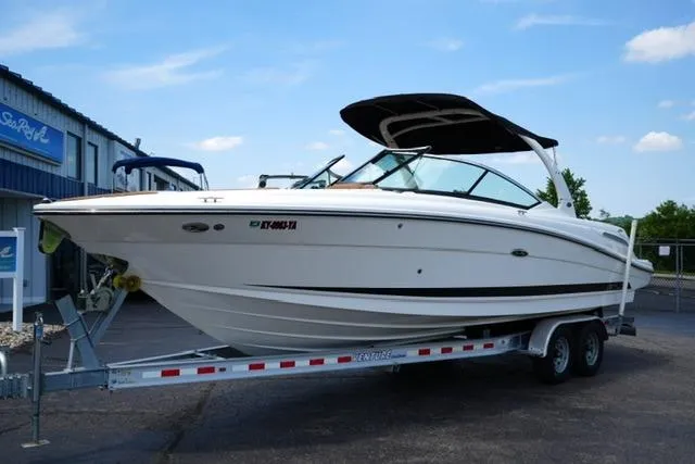 Slide: The Image of 2014 Sea Ray 270 SLX boat on trailer, parked outdoors under clear sky. - 2