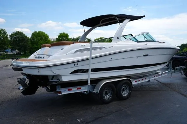 Slide: The Image of 2014 Sea Ray 270 SLX boat on trailer, white exterior, black canopy, parked outdoors. - 5