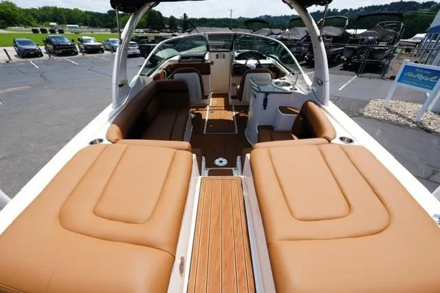 Slide: The Image of 2014 Sea Ray 270 SLX boat interior with tan leather seating and wood accents. - 8