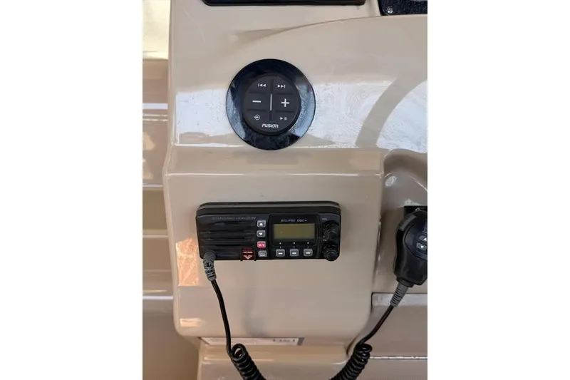 Slide: The Image of Control panel of a 2007 Sea Ray 240 Sundancer boat with radio and audio controls. - 11