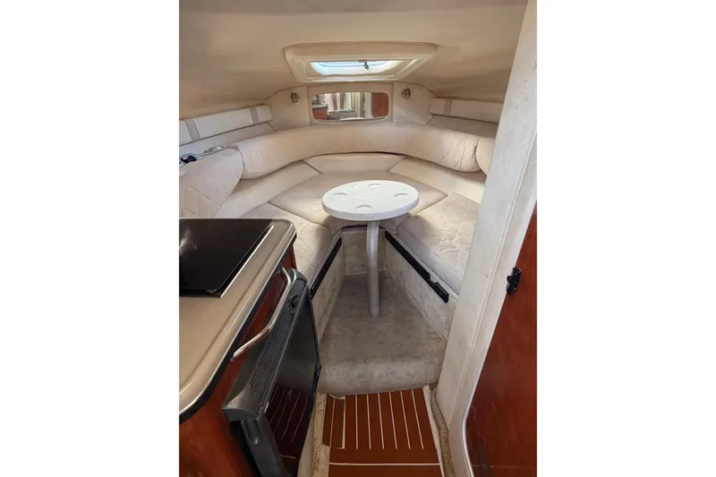 Slide: The Image of 2007 Sea Ray 240 Sundancer cabin interior with seating and table. - 17