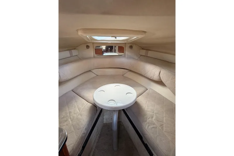 Slide: The Image of Interior cabin of 2007 Sea Ray 240 Sundancer with cushioned seating and table. - 18