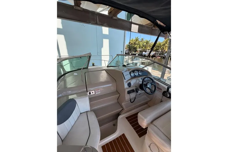Slide: The Image of 2007 Sea Ray 240 Sundancer boat interior with steering wheel and dashboard controls. - 7