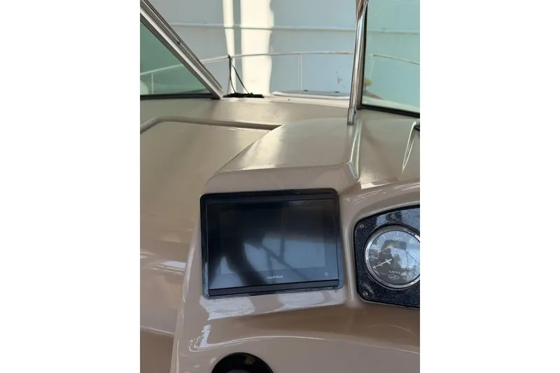Slide: The Image of 2007 Sea Ray 240 Sundancer dashboard with Garmin display and speedometer. - 9