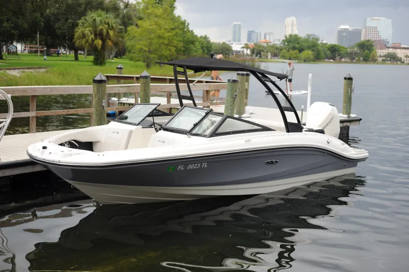 The Image of 2023 Sea Ray SPX 210 Outboard boat docked on a calm lake. - 0