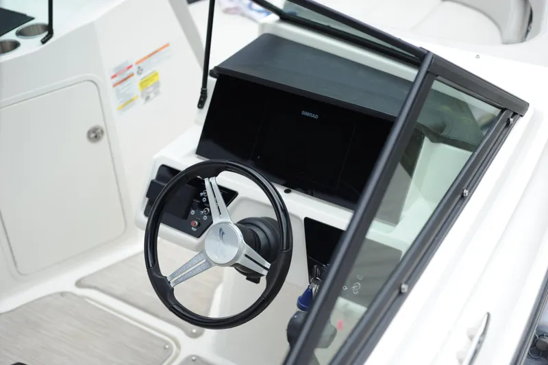 Slide: The Image of 2023 Sea Ray SPX 210 Outboard steering wheel and dashboard close-up. - 13
