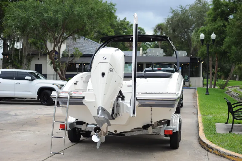 Slide: The Image of 2023 Sea Ray SPX 210 Outboard boat on trailer, parked outdoors. - 3