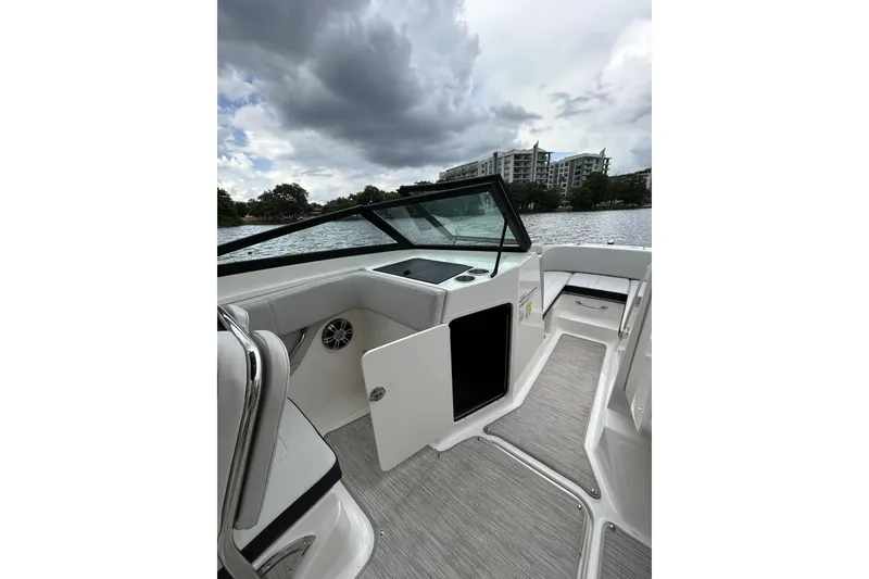 Slide: The Image of 2023 Sea Ray SPX 210 Outboard interior with open storage, lake view, and modern design. - 8