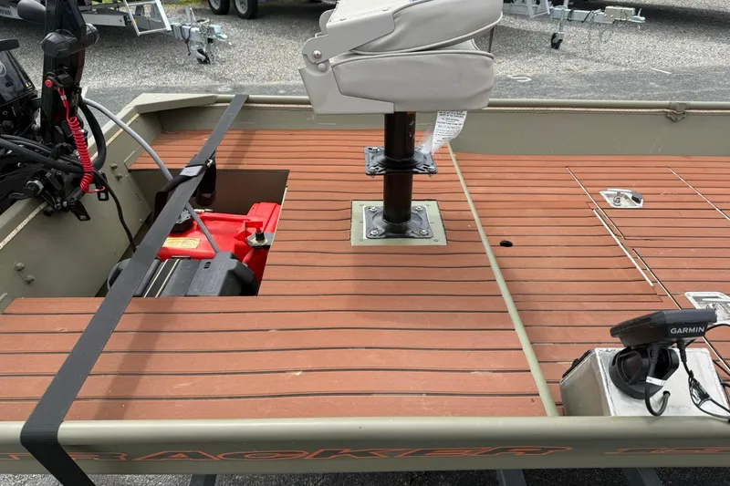 Slide: The Image of 2025 Tracker Grizzly 1542 boat interior with wooden deck and mounted seat. - 10