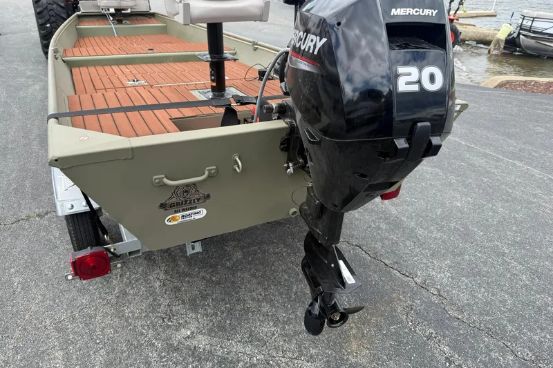 Slide: The Image of 2025 Tracker Grizzly 1542 boat with Mercury 20 outboard motor on trailer. - 2