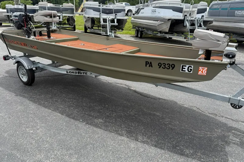 Slide: The Image of 2025 Tracker Grizzly 1542 boat on LoadRite trailer, parked outdoors. - 5