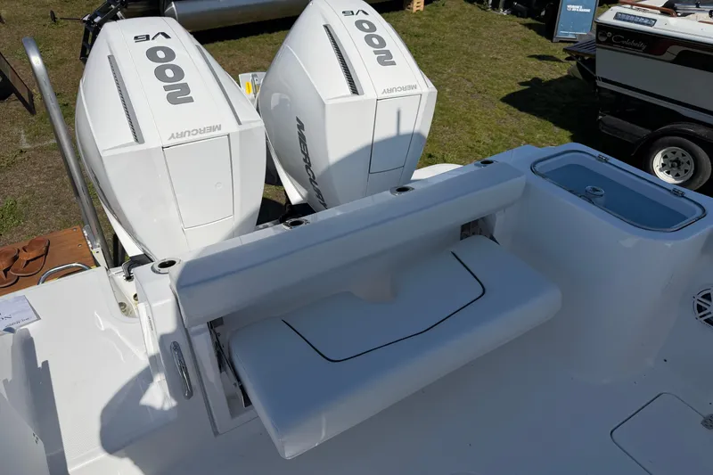 Slide: The Image of 2026 Wellcraft 243 Fisherman boat with dual Mercury 200 V6 engines, rear seating, and livewell. - 10