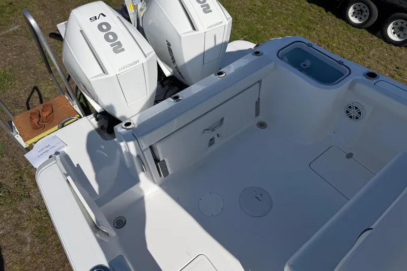 Slide: The Image of 2026 Wellcraft 243 Fisherman boat deck with twin Mercury engines. - 11