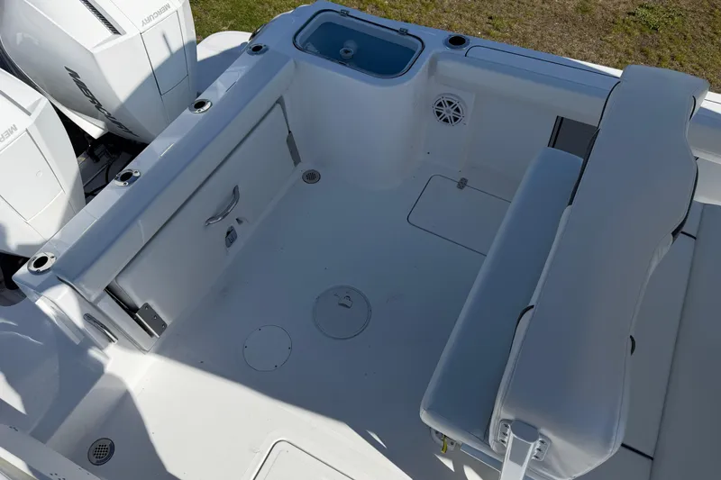 Slide: The Image of 2026 Wellcraft 243 Fisherman boat interior with seating and storage compartments. - 12