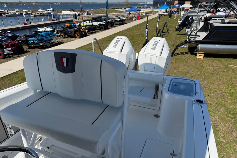 Slide: The Image of 2026 Wellcraft 243 Fisherman boat with dual engines displayed at a marina event. - 5