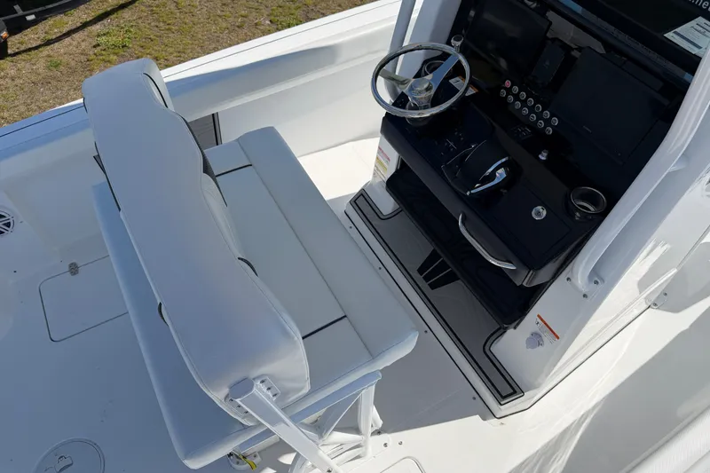 Slide: The Image of 2026 Wellcraft 243 Fisherman boat cockpit with steering wheel and seating. - 6