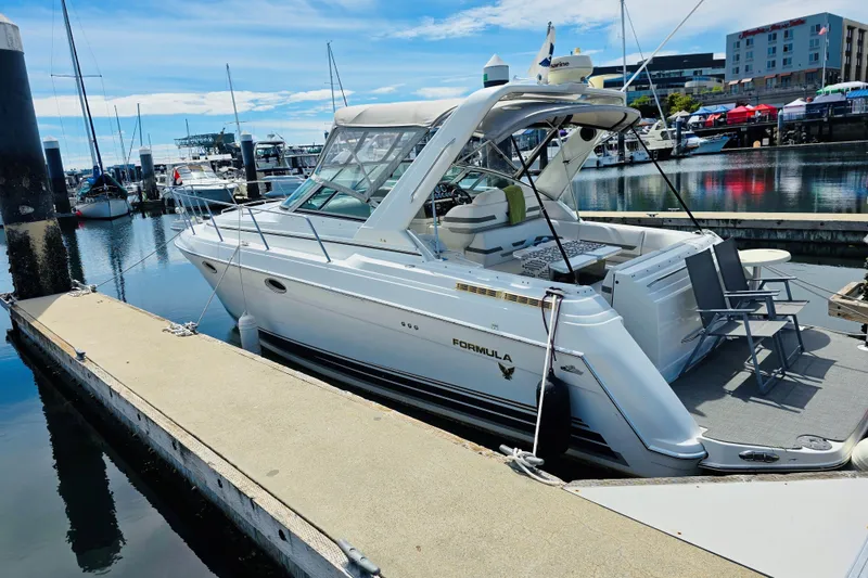 The Image of 2003 Formula 31 Performance Cruiser docked at a marina under a clear blue sky. - 1