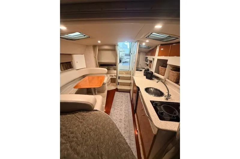 Slide: The Image of 2003 Formula 31 Performance Cruiser interior with kitchen, seating, and dining area. - 16
