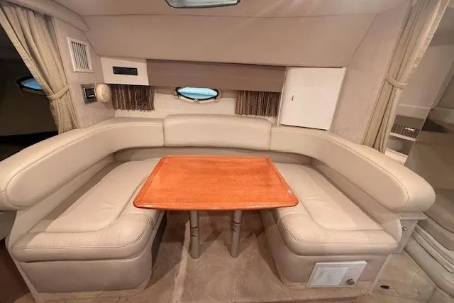 Slide: The Image of Interior of 2003 Formula 31 Performance Cruiser with beige seating and wooden table. - 18