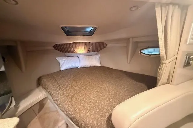 Slide: The Image of 2003 Formula 31 Performance Cruiser cabin interior with cozy bed and porthole window. - 19