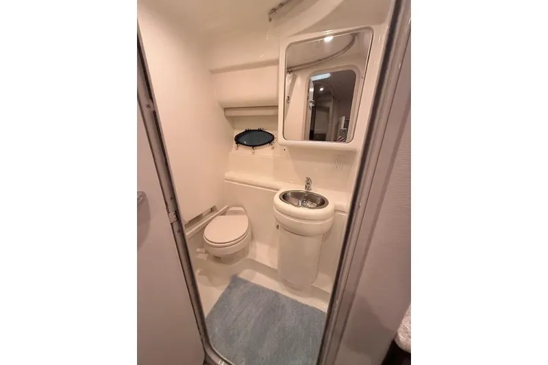 Slide: The Image of 2003 Formula 31 Performance Cruiser bathroom with toilet, sink, mirror, and compact design. - 22