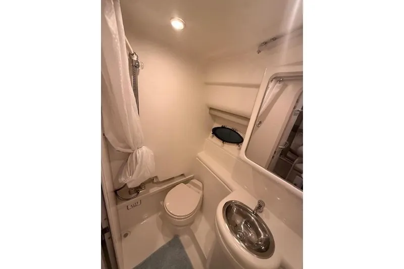 Slide: The Image of 2003 Formula 31 Performance Cruiser bathroom with toilet, sink, and shower. - 23