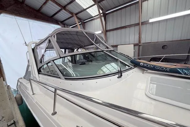 Slide: The Image of 2003 Formula 31 Performance Cruiser in a boat shed, featuring sleek design and covered cockpit. - 3