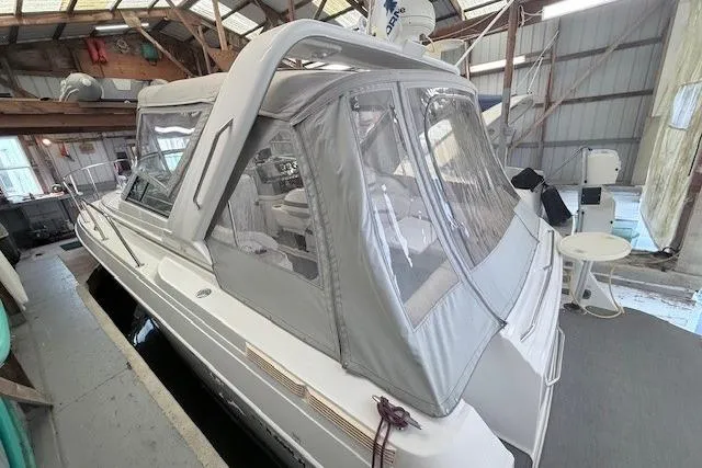 Slide: The Image of 2003 Formula 31 Performance Cruiser in a covered dock, featuring a gray canopy. - 4