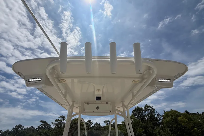Slide: The Image of T-top of 2015 Sailfish 240 CC boat under a sunny, partly cloudy sky. - 11